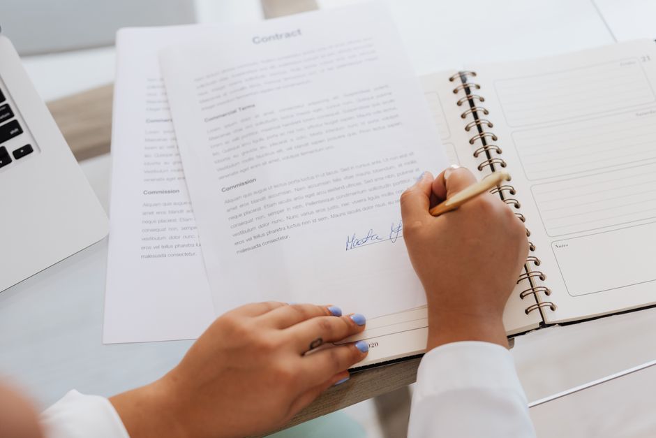 A professional reviewing and signing regulatory documents