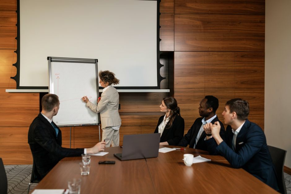 A financial professional leading a boardroom presentation on strategy