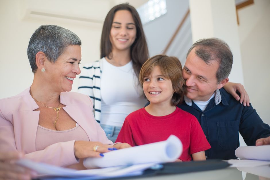 A young professional signing a financial agreement with a parent, representing a cosigner.