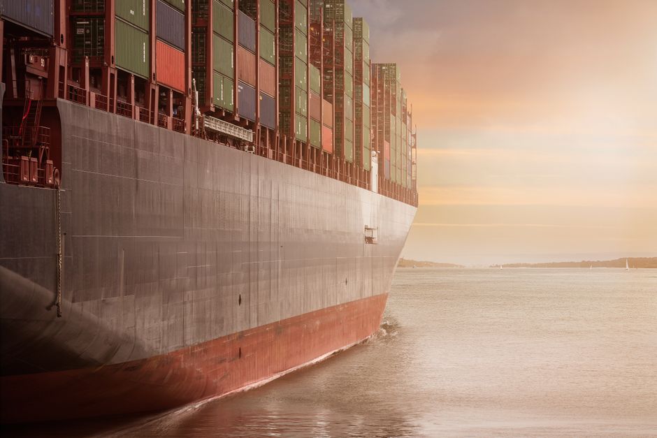 A world map representation with cargo ship routes showing global e-commerce logistics