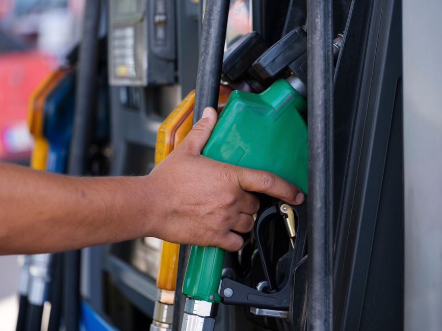 A close-up of a fuel nozzle at a gas station, representing fuel excise taxes.
