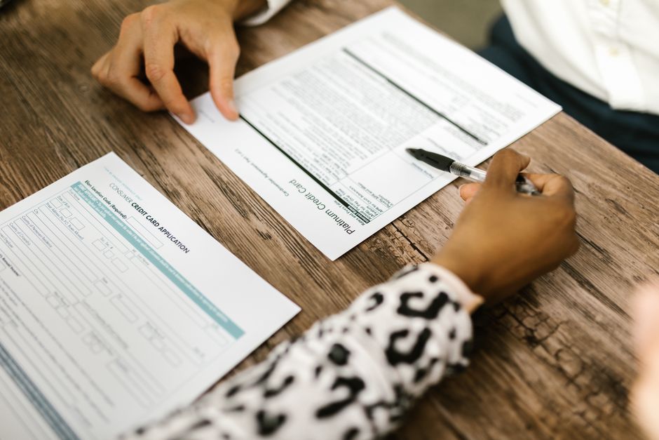 Business professionals discussing a credit agreement or debt covenant compliance in a corporate office.