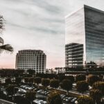 A successful finance executive looking at a city skyline from a modern office