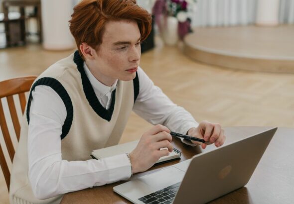 A student studying accounting online using a laptop