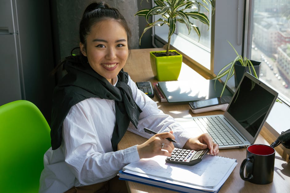 A self-taught student studying accounting concepts on a laptop at a bright desk