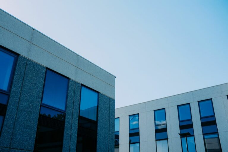 A modern glass office building representing leased corporate real estate