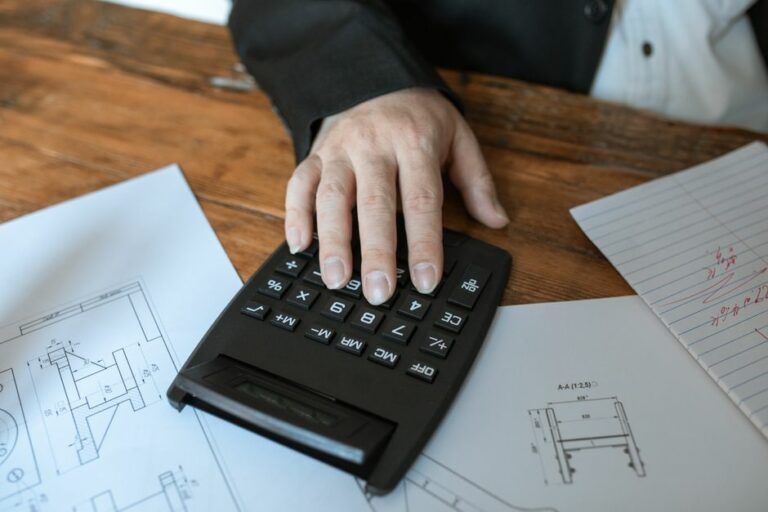 A professional desk with financial reports, a calculator, and a pen representing the importance of accounting in business