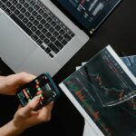 A beginner looking at a stock portfolio on a smartphone screen, displaying a simple and clean interface with charts.
