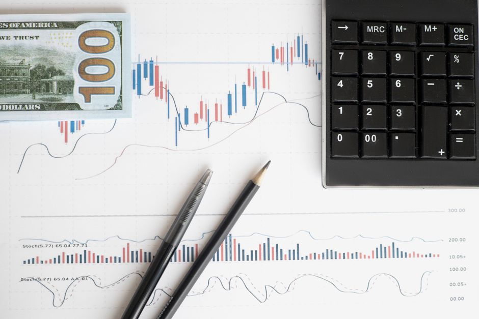 A professional accountant analyzing large financial datasets on a dual-screen dashboard in a high-tech office.