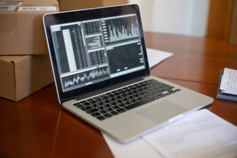 An accountant reconciling a company ledger on QuickBooks Online on a modern computer display.