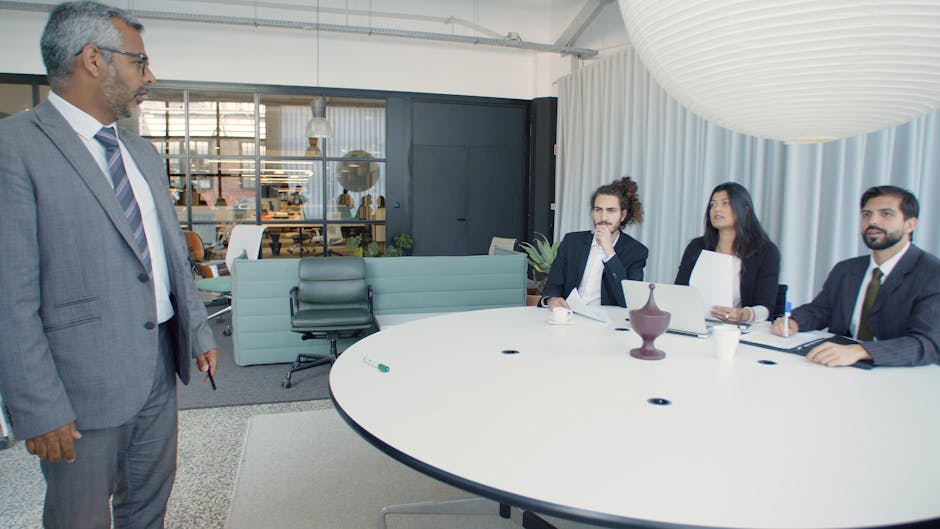 A professional business meeting inside a modern office conference room