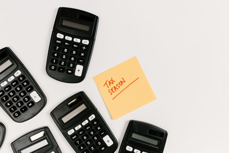 A CPA analyzing salary sheets and financial credentials on a desk.