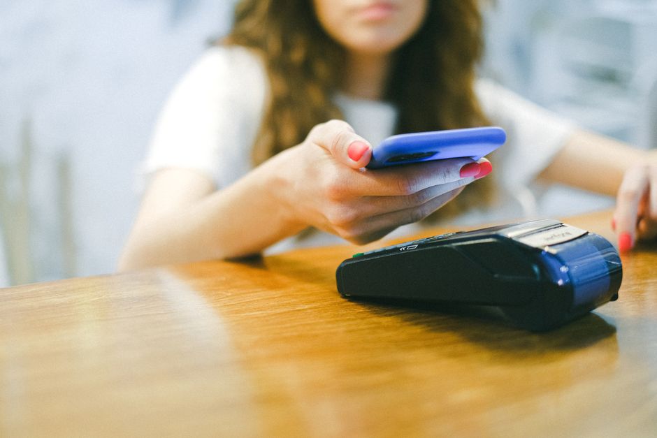 A close-up of a smartphone showing a successful automatic bill payment confirmation.