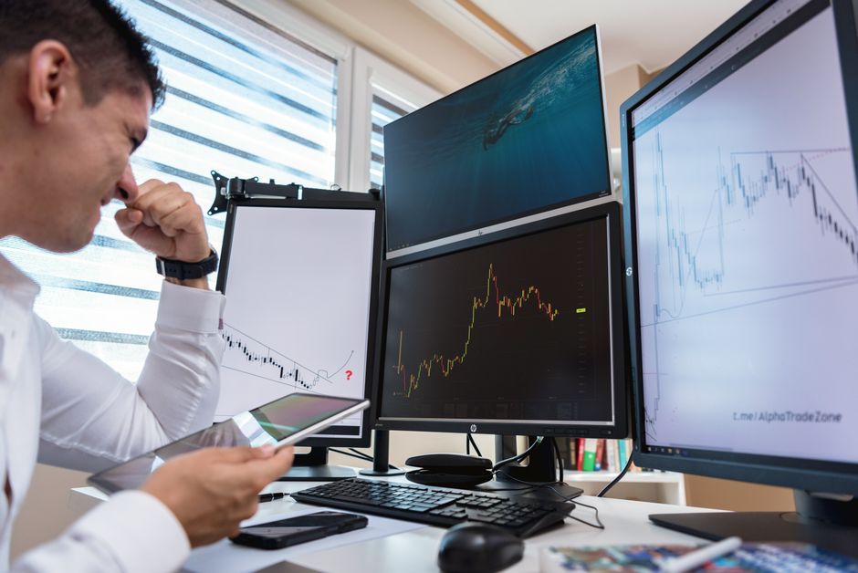 An investor reviewing asset allocations on a tablet in a modern office.