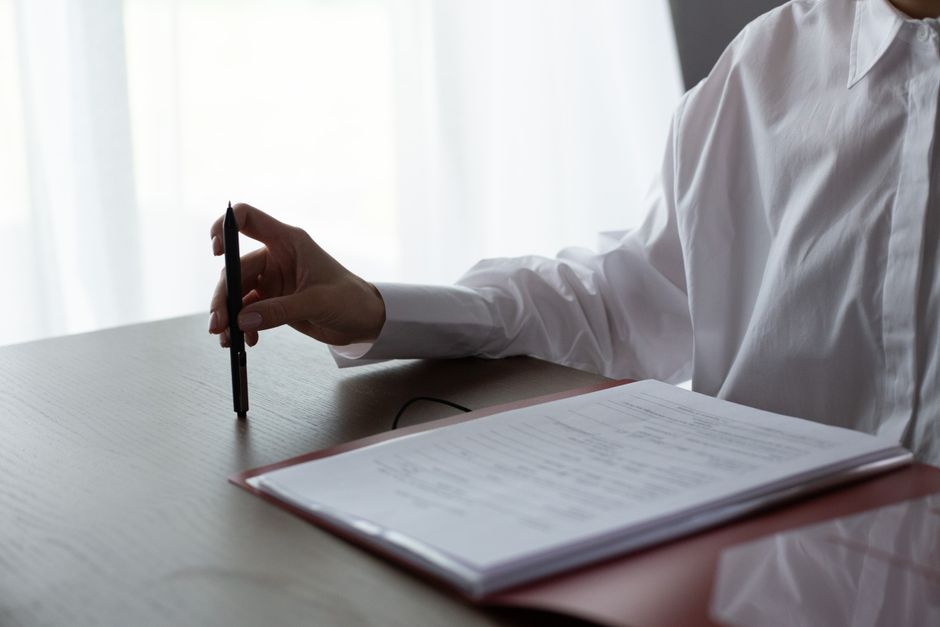 An auditor verifying environmental accounting data at a desk