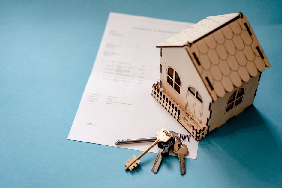 House keys and a contract representing real estate investment