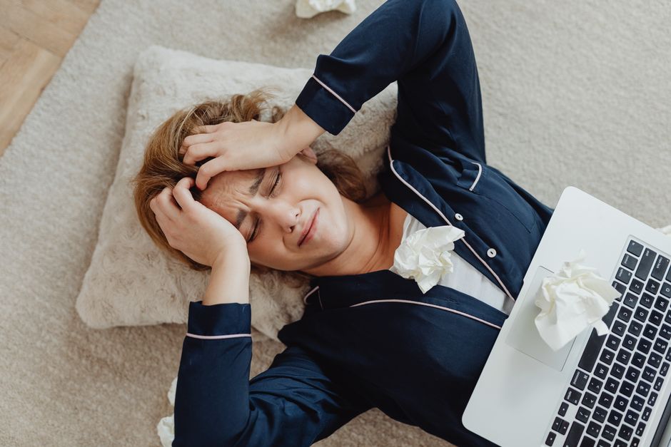 An overworked office professional feeling stressed by high workloads