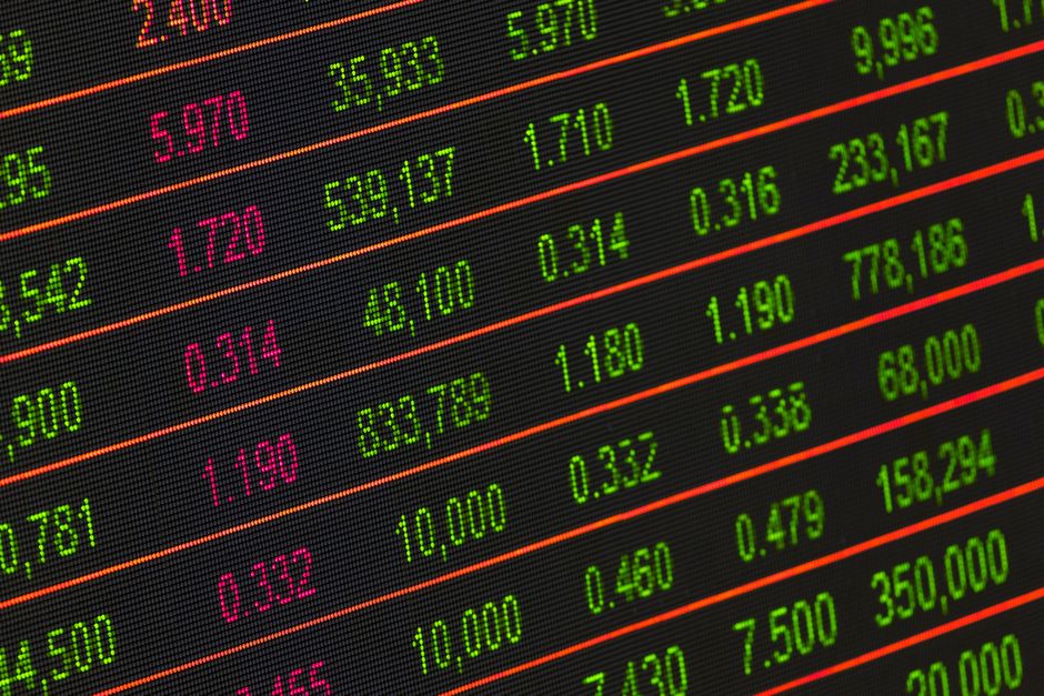 A digital stock board displaying red figures across multiple sectors representing a market downturn.