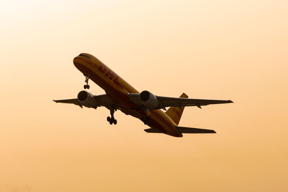 A commercial cargo airplane and a logistics hub, representing sectors heavily impacted by lease capitalization.