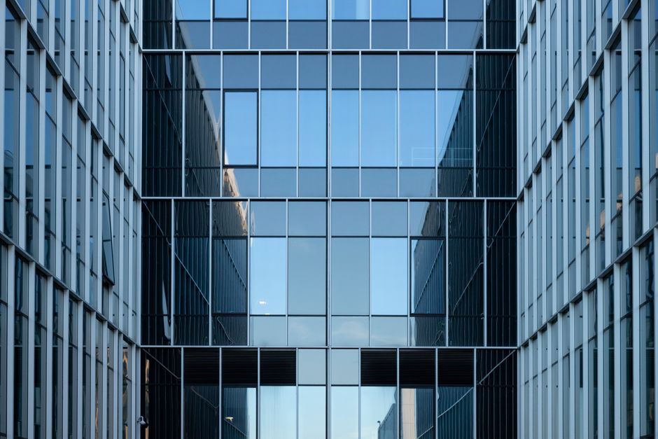 Modern office building with glass windows representing leased real estate