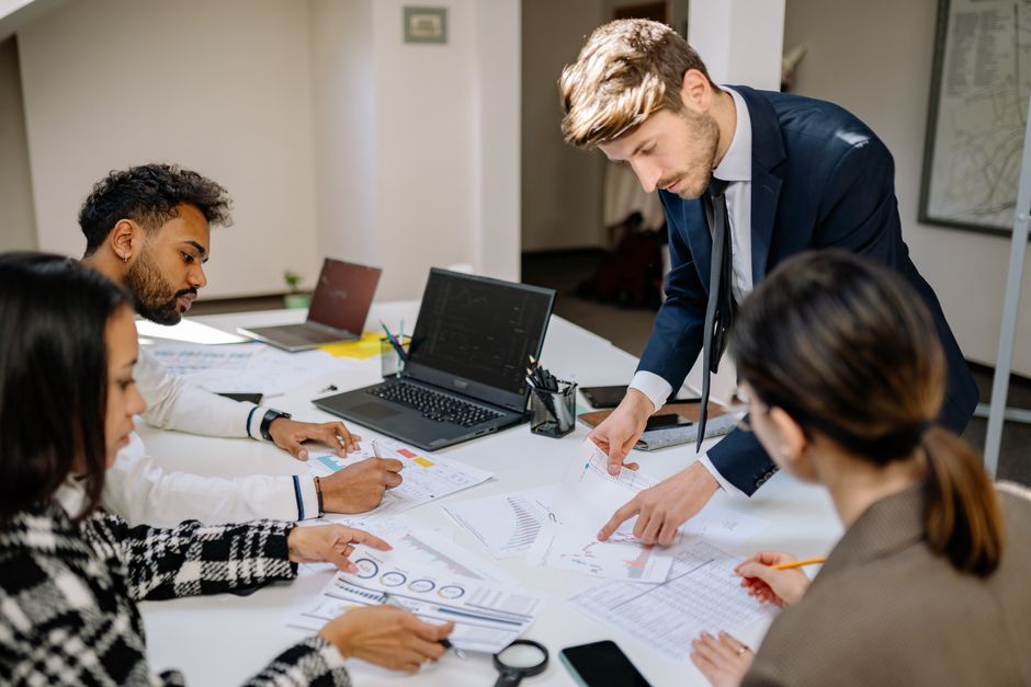 An accounting team reviewing financial documents together