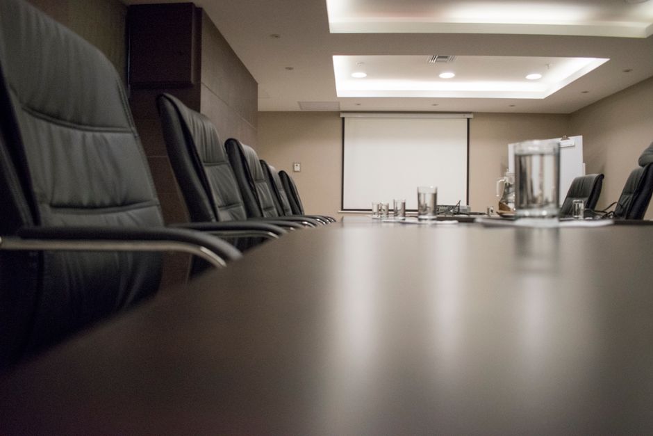 Accounting standard-setters in a corporate boardroom meeting.