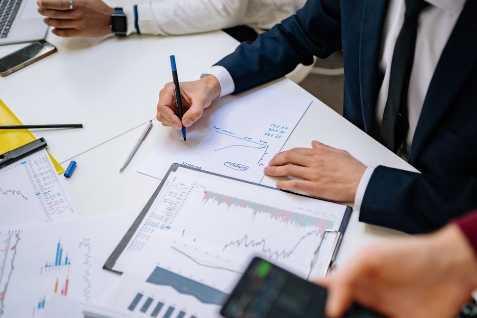 A finance professional processing transaction data on a modern office workstation