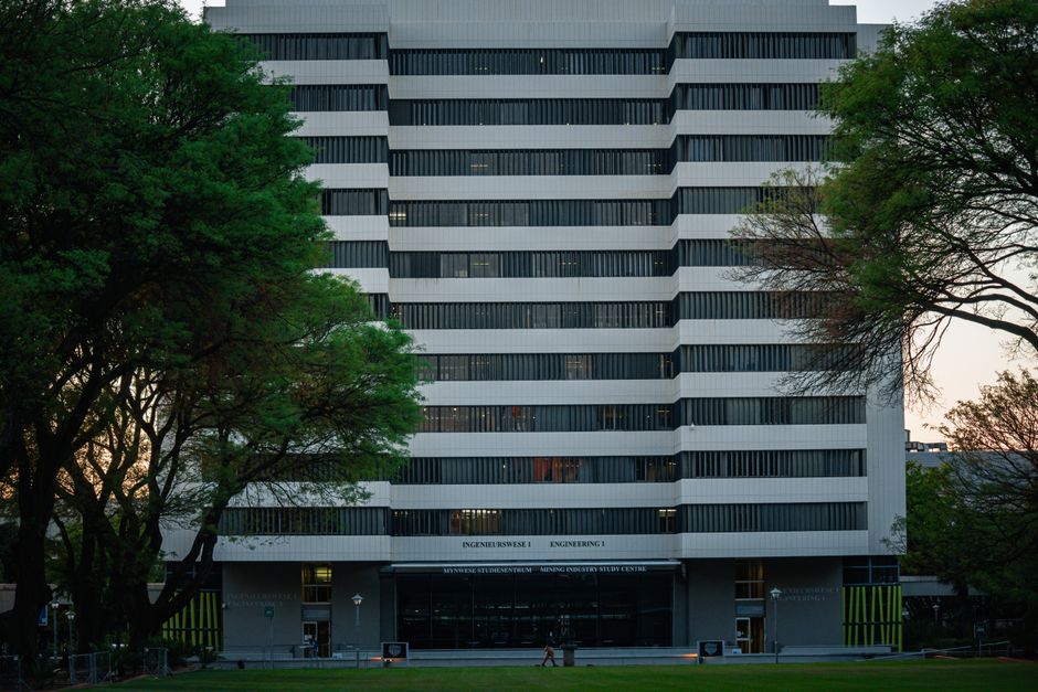 A large university campus building representing traditional education