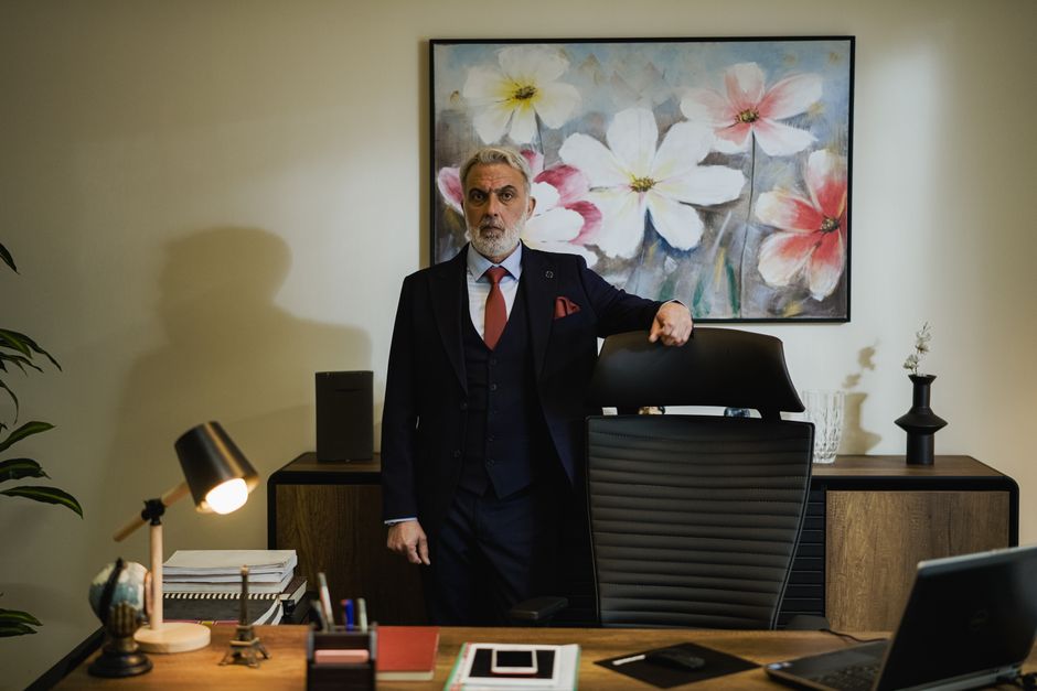 A professional CPA reviewing corporate financial sheets at a desk