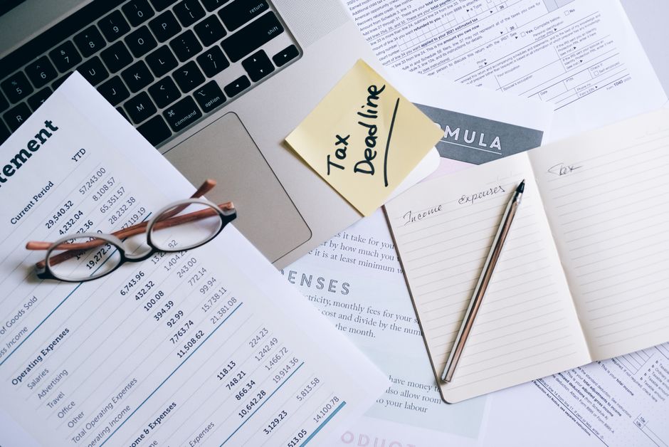 A checklist with compliance marks and tax forms.
