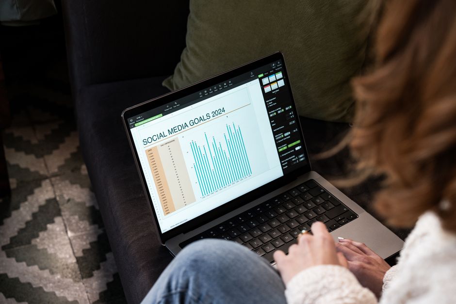 A laptop displaying social media analytics and financial forums