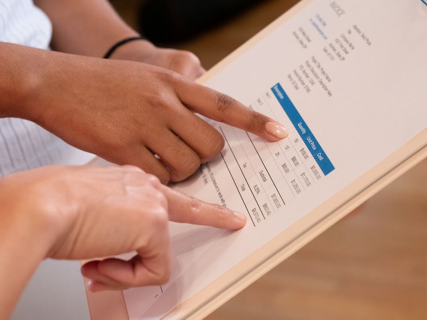 A commercial property manager reviewing maintenance contract invoices.