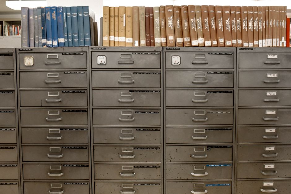 Organized filing cabinet folders representing archived financial records.