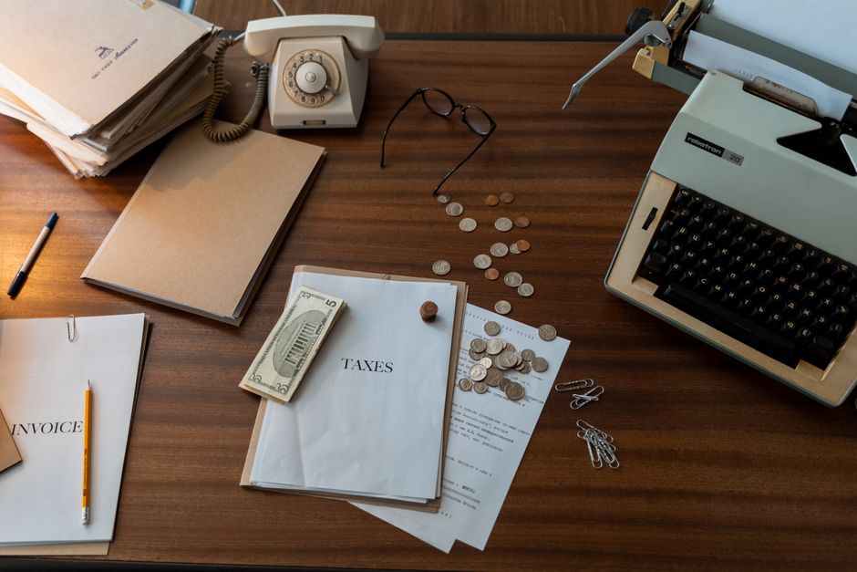 A corporate bookkeeper reviewing invoices and financial statements