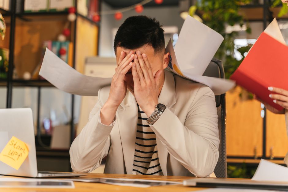 An office professional organizing messy papers and documents.