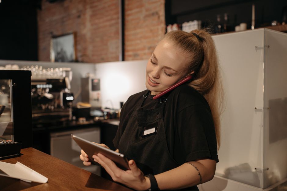 A technician using a tablet software app to manage invoices and job expenses.
