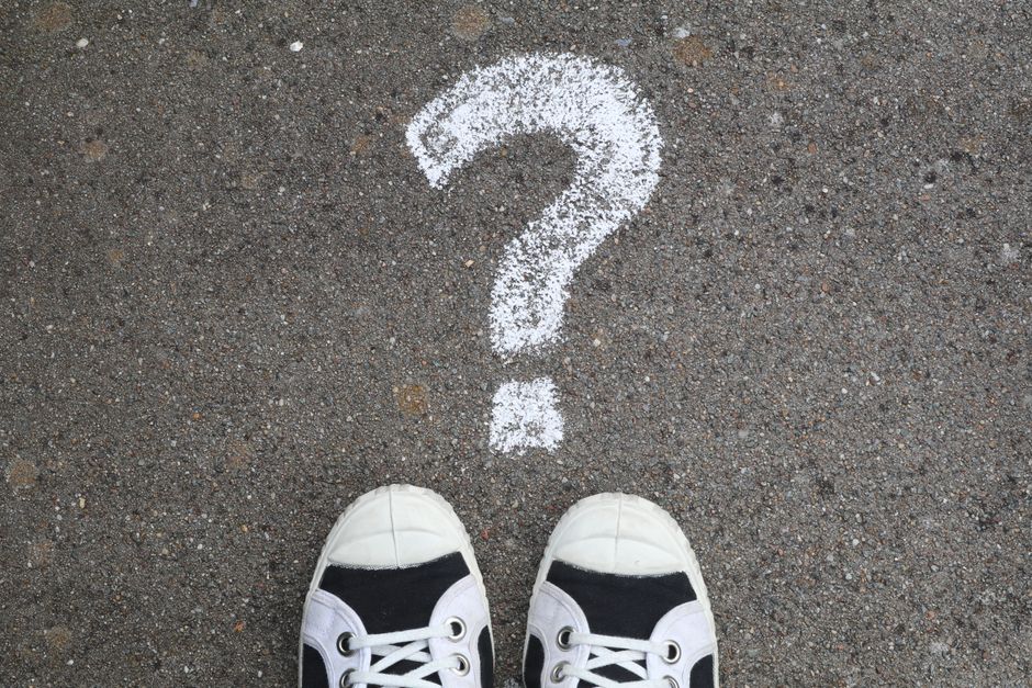 A chalkboard with question marks representing frequently asked questions.