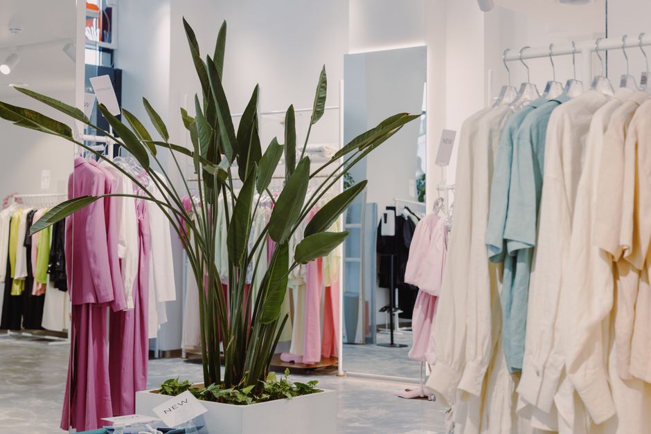 A modern boutique retail store displaying clothing and accessories.