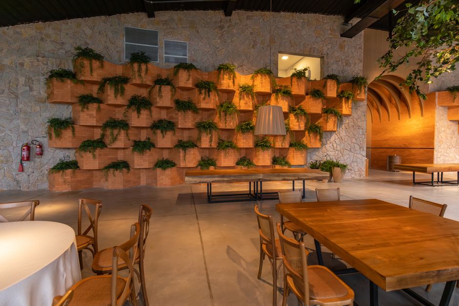 An eco-friendly restaurant dining space featuring live indoor plants and natural lighting.