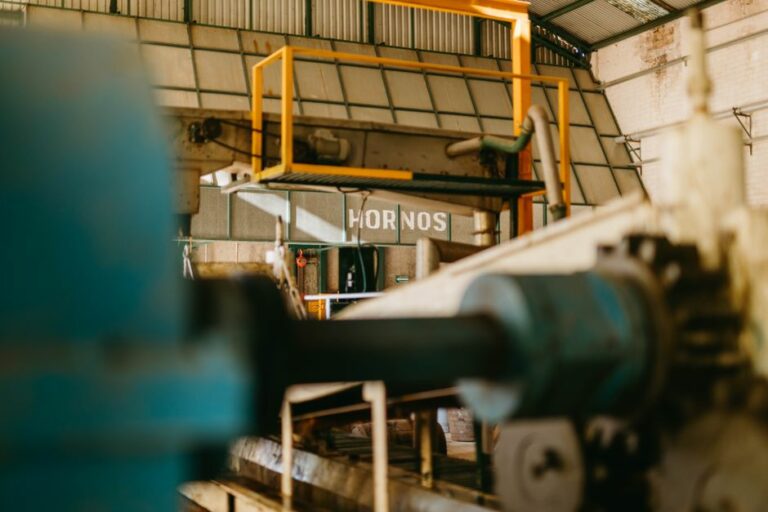 A large robotic assembly arm working in an advanced manufacturing facility.