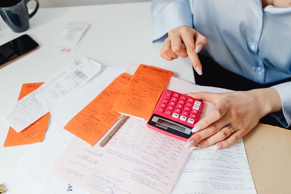 Financial documents, invoices, and accounting files on a small business desk.