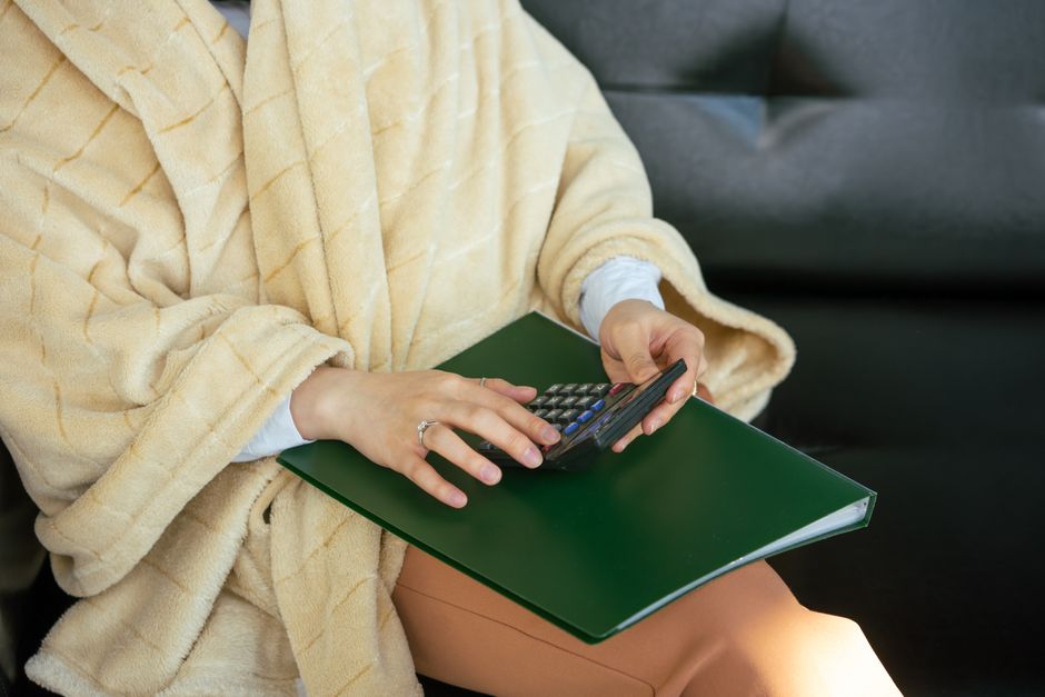 A student using a calculator and studying financial accounting documents