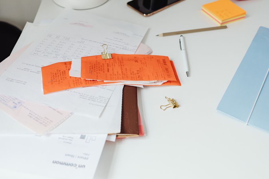 An office desk with invoices and calculators for accounts payable.
