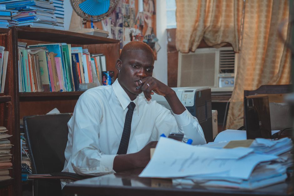 An accounting manager working at a desk reviewing financial documents.