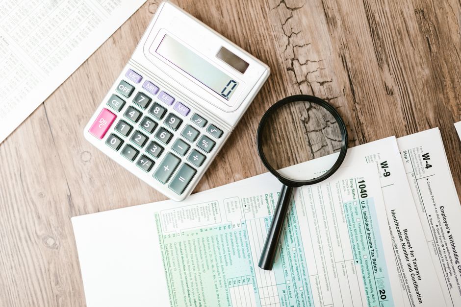 Magnifying glass over corporate financial audit documents.