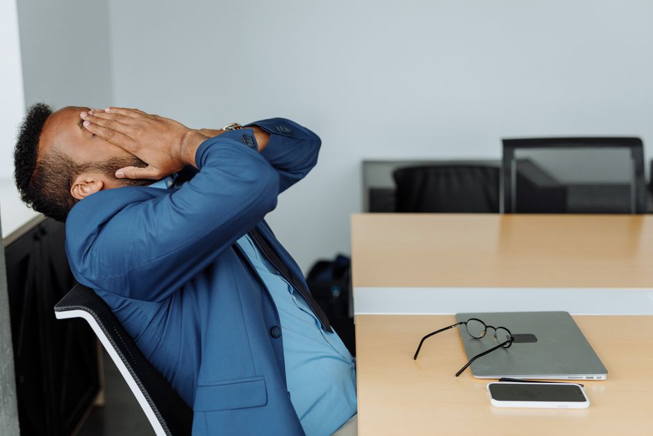 A stressed corporate officer looking at declining numbers on a chart.