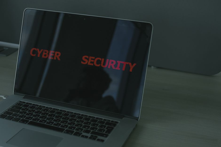 A secure laptop showing cyber security visual graphs.