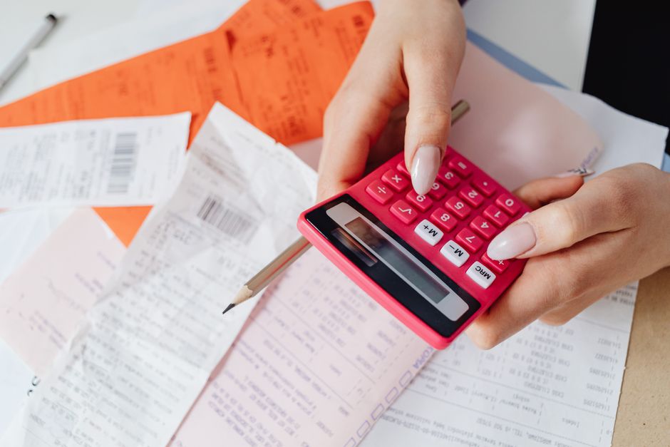 An accountant analyzing and verifying business receipts and invoices.