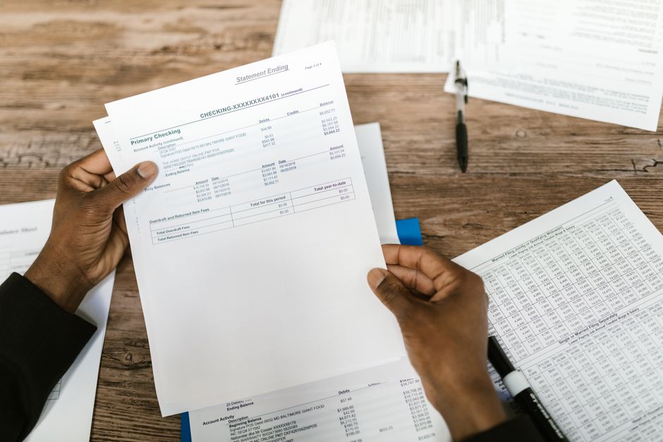 Bookkeeper reconciling bank statements as part of a monthly service