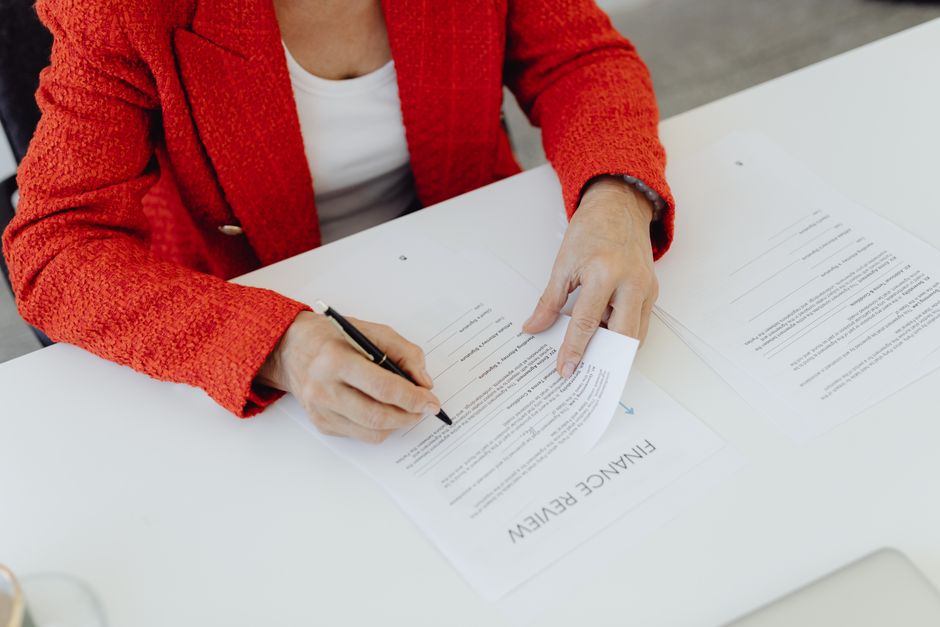 A CPA reviewing revenue recognition contracts and hash rate agreements on a desk